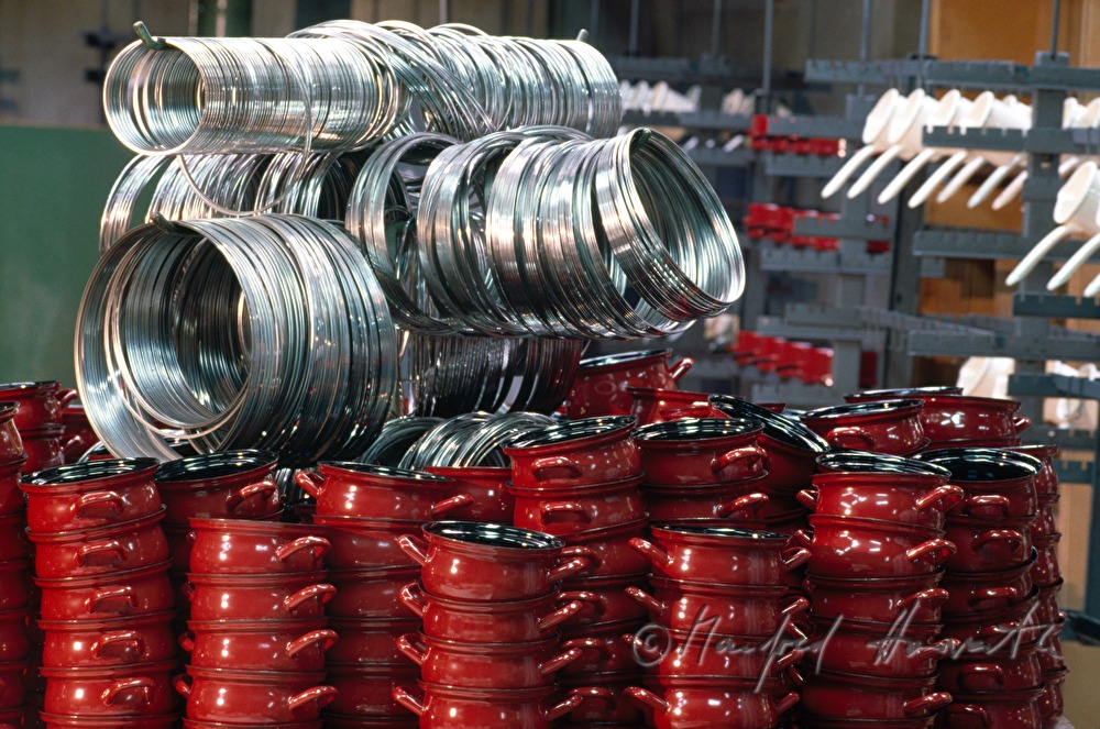 a heap of red enamel pots