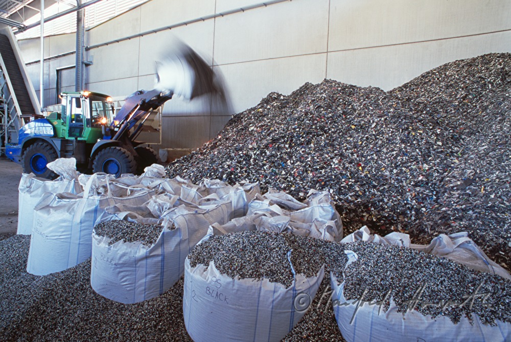 heap of plastic waste and heavy duty vehicle