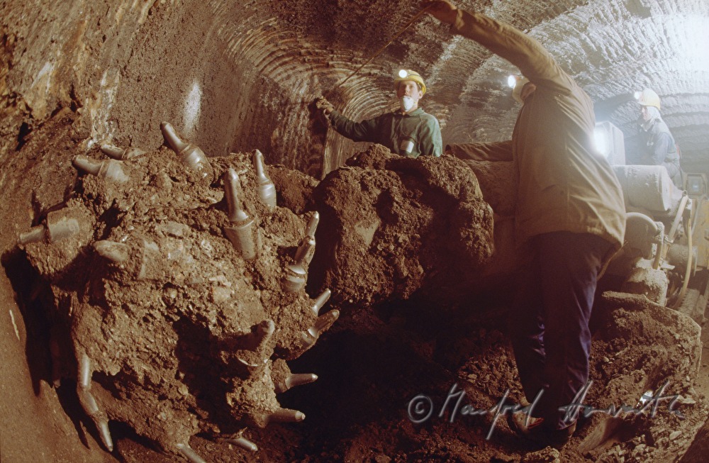 pitmen with rock driller in the tunnel
