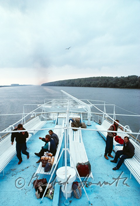 passengers on the deck of a ferry boat