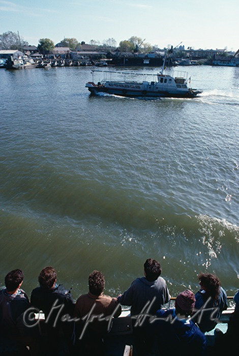 passengers on the deck of a ferry boat