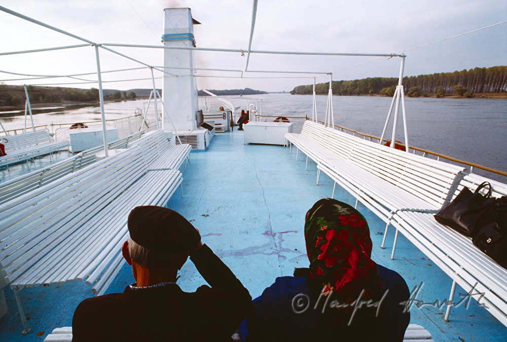 passengers on the deck of a ferry boat
