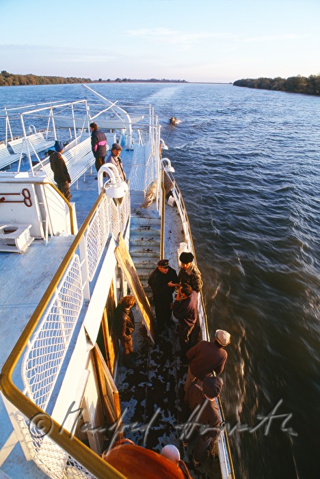 passengers on the deck of a ferry boat