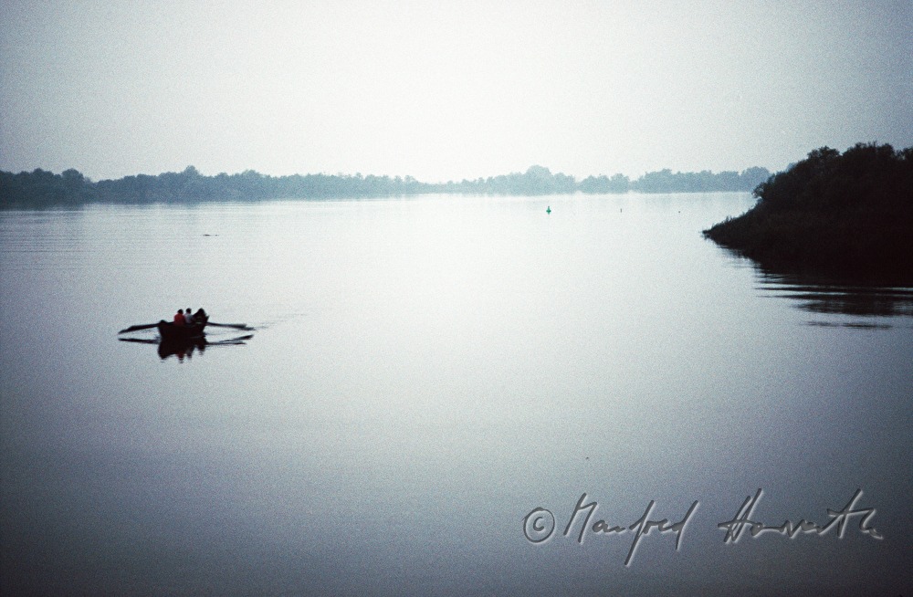 fisherman rowing to the nets