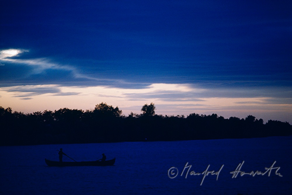fisherman rowing to the nets