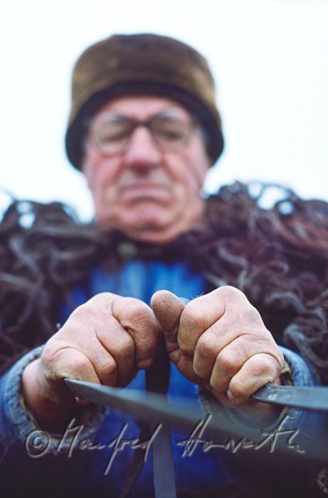 farmer with fur coat on his horse-drawn vehicle