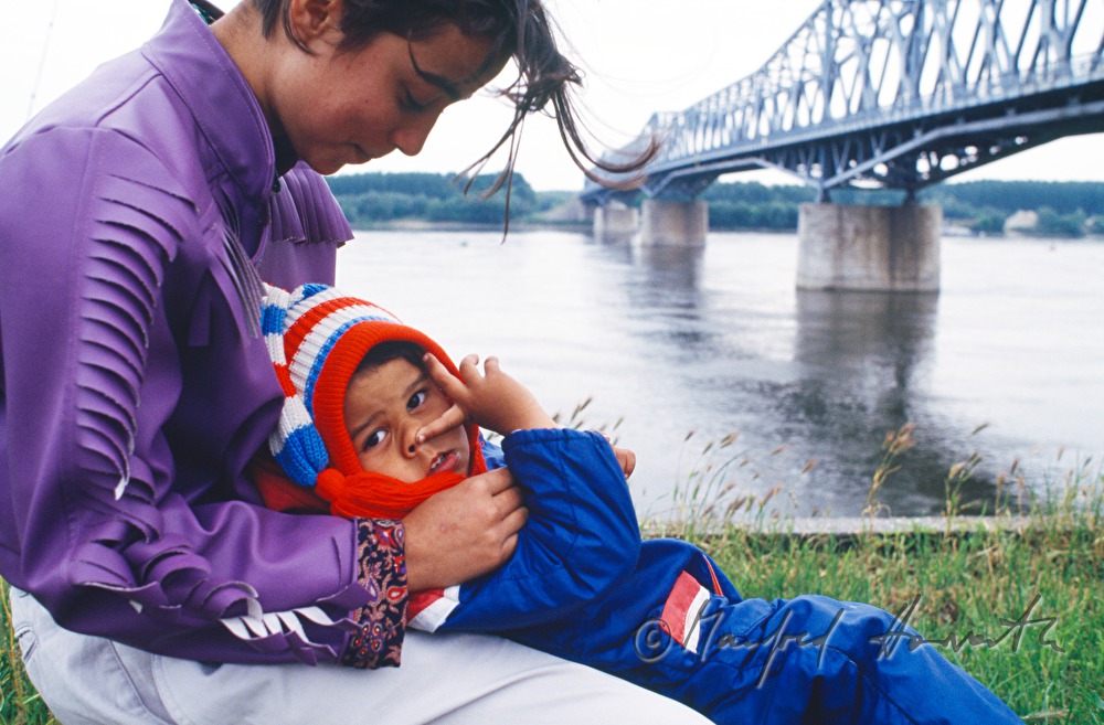 joung mother with child on the rivershore of the Danube
