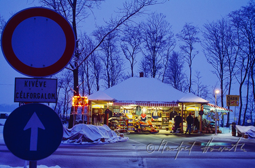 kiosk near the street and traffic signs