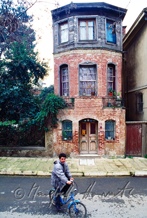 bicycle rider and narrow mansion