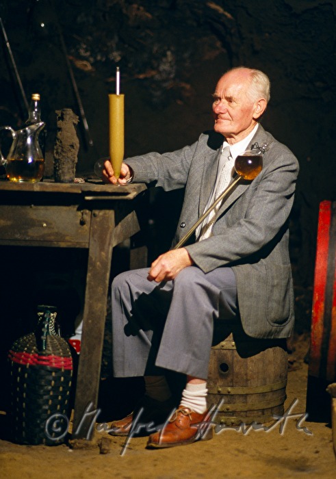 vintner doing wine anylysis in the wine cellar