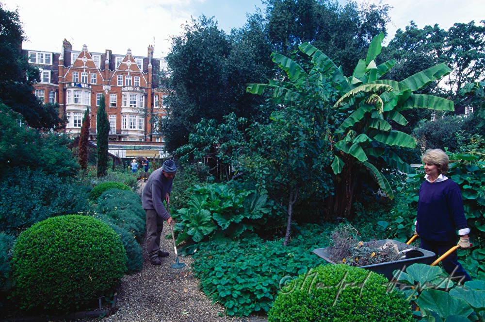 workers clean the gravel walk