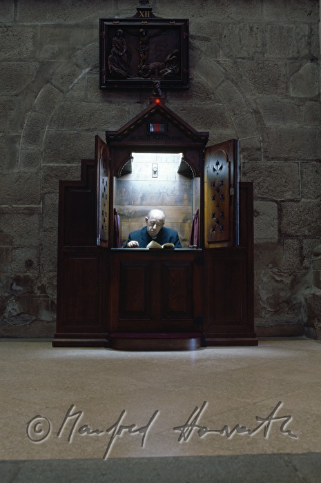 priest in the confessional box