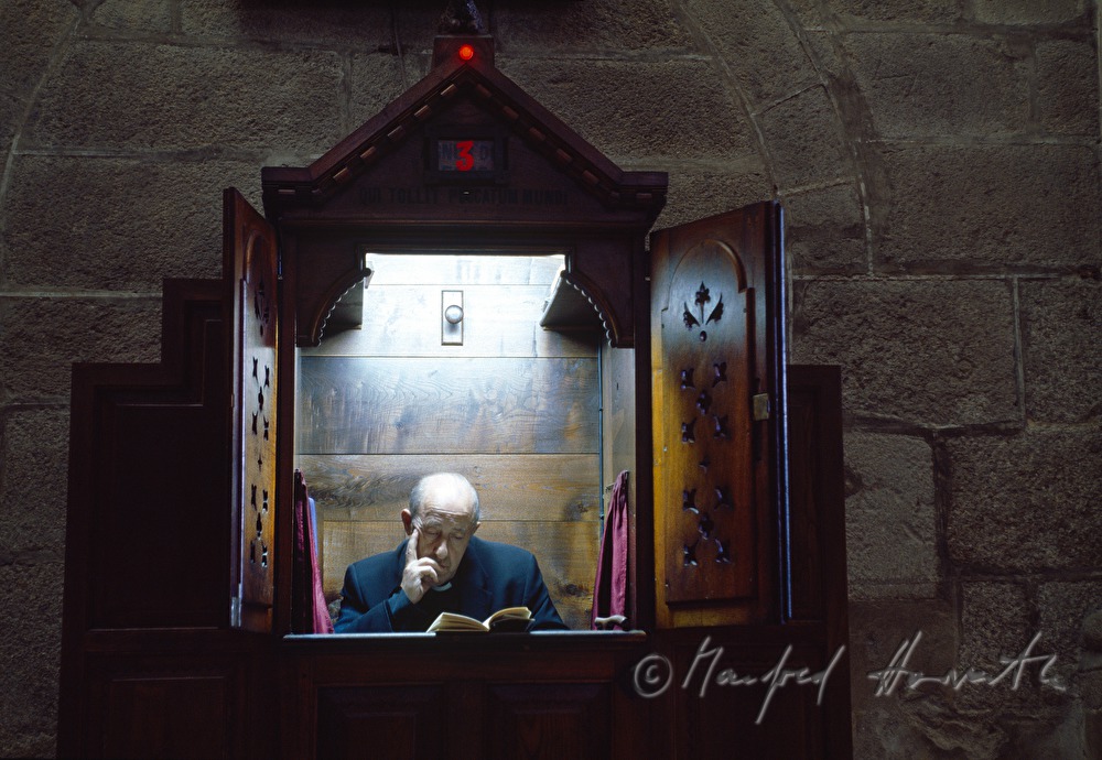priest in the confessional box