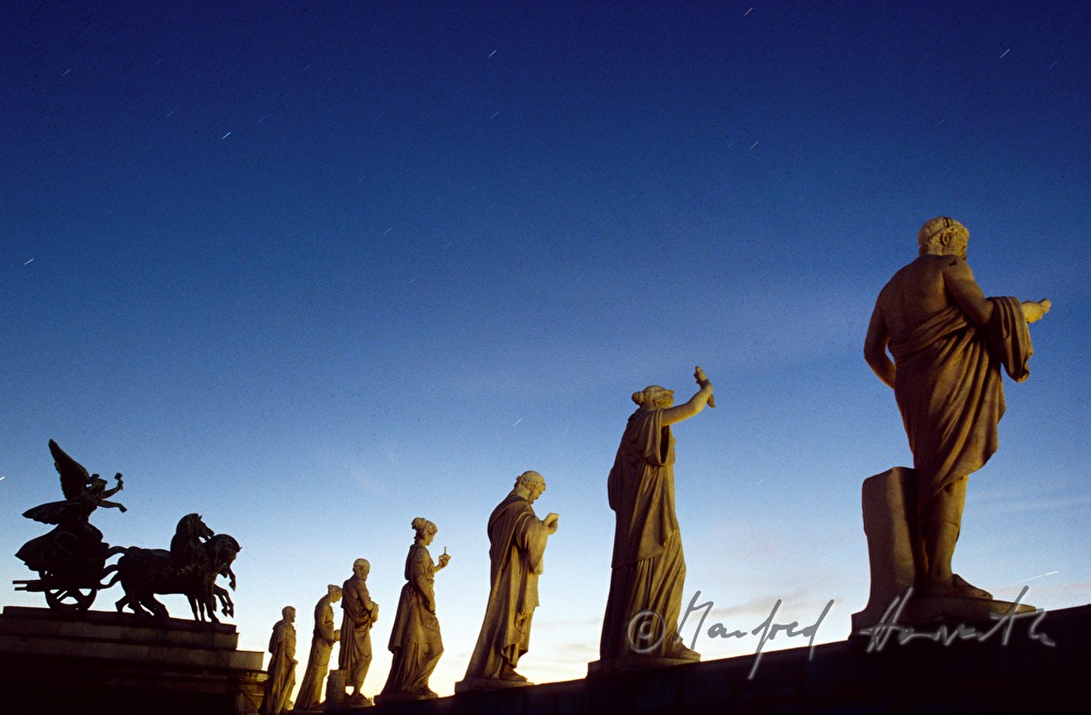 statues on roof of parliament