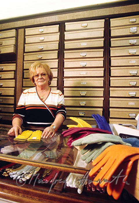the owner of the specialised shop with different gloves