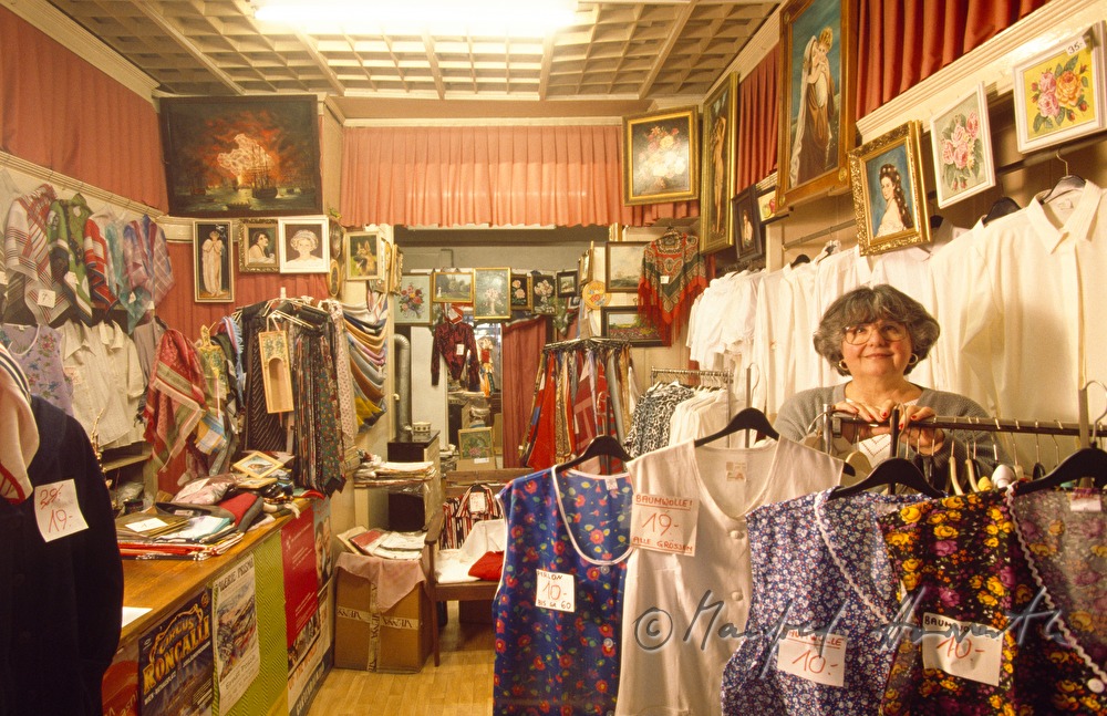 the owner of the specialised shop with different blouses