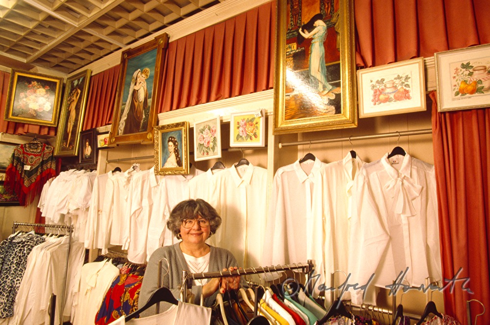 the owner of the specialised shop with different blouses