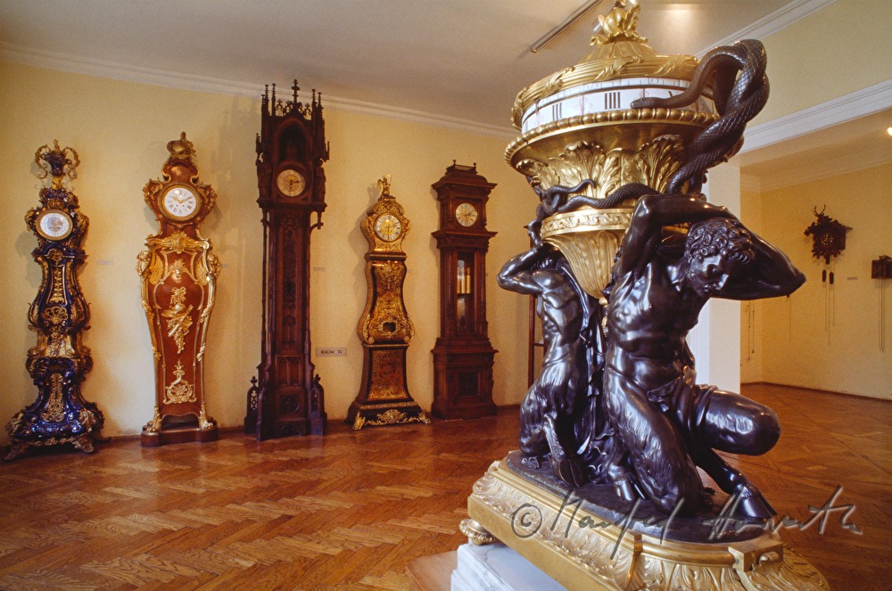display room with wall clocks and floor clocks