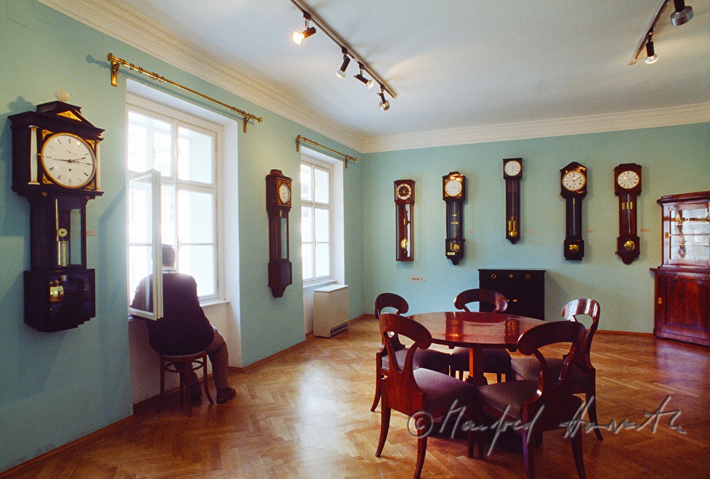 display room with wall clocks and floor clocks