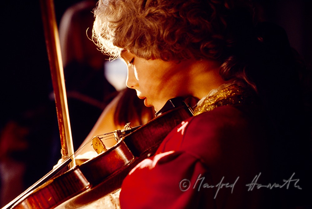 boy in Mozart outfit plays violin