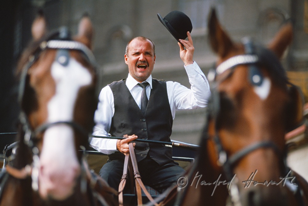 a Fiaker (horse carriage driver) waving greetings