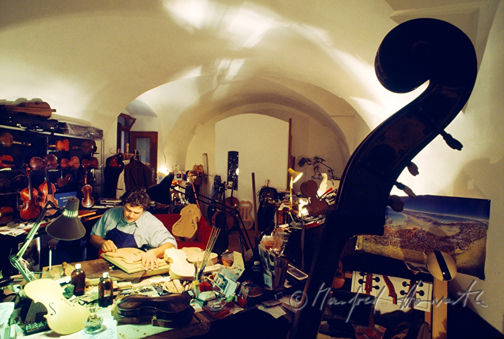 violin maker in his workshop