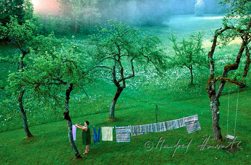 countrywoman pegs up clothes