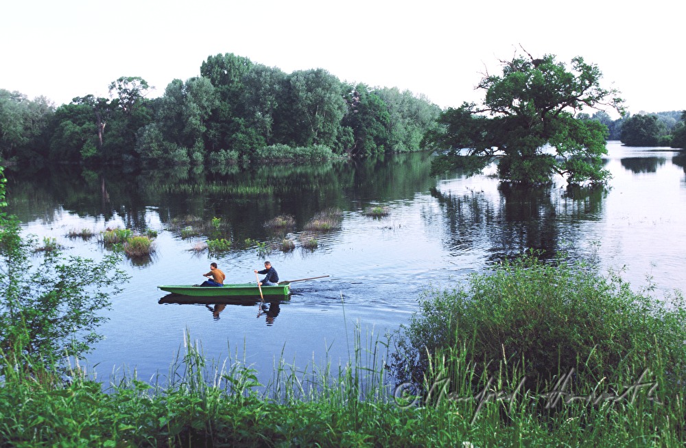 flooded alluvial land, rangers in boat