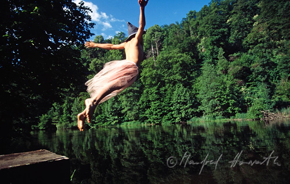 costumed boy jumps into the water