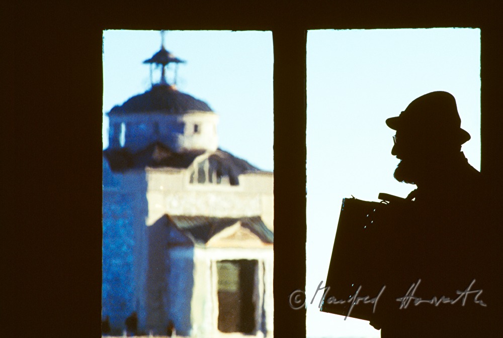 accordeon player and view through the window