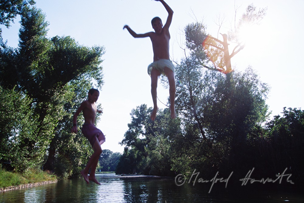 boys jumping from a bridge into the Danube