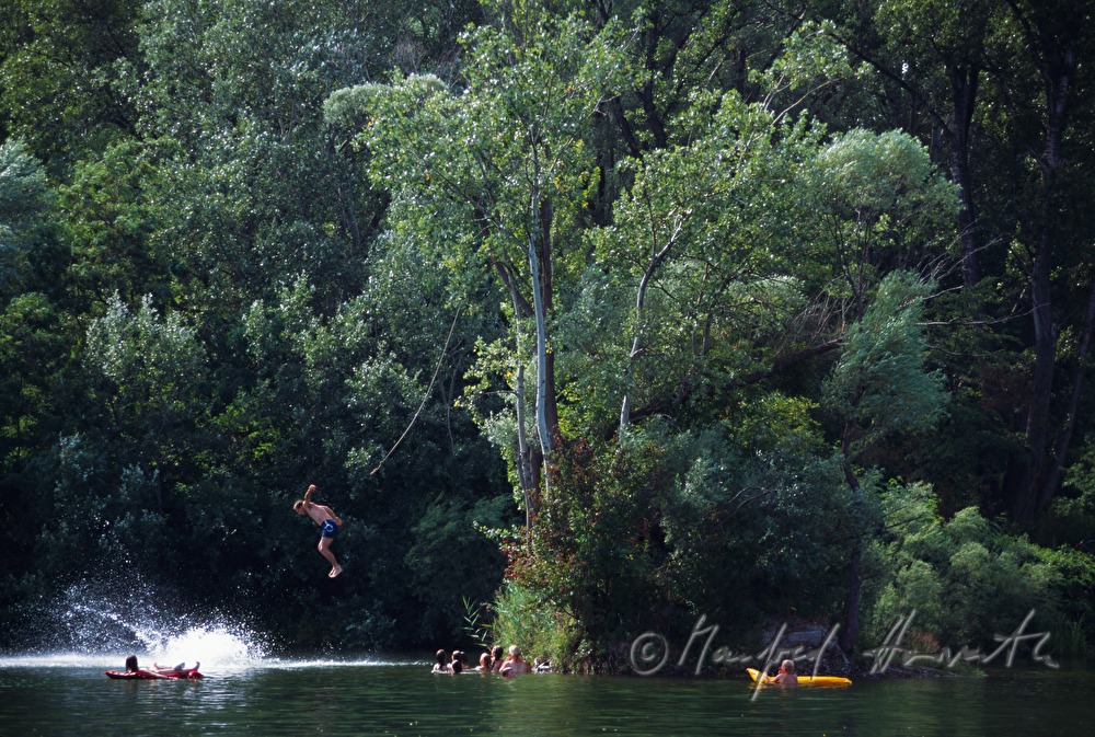 boy jumping into the lake