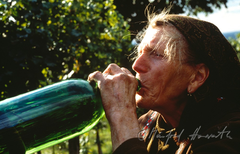 countrywoman takes a sip of wine