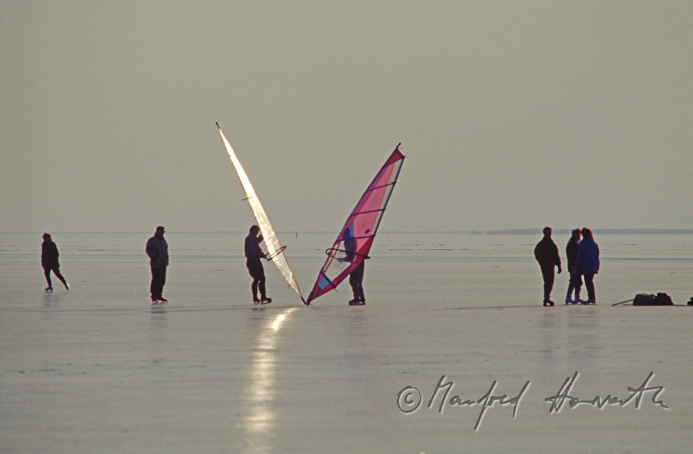 ice-skaters and ice-surfers on the lake