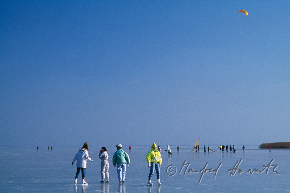 ice-skaters and ice-surfers on the lake