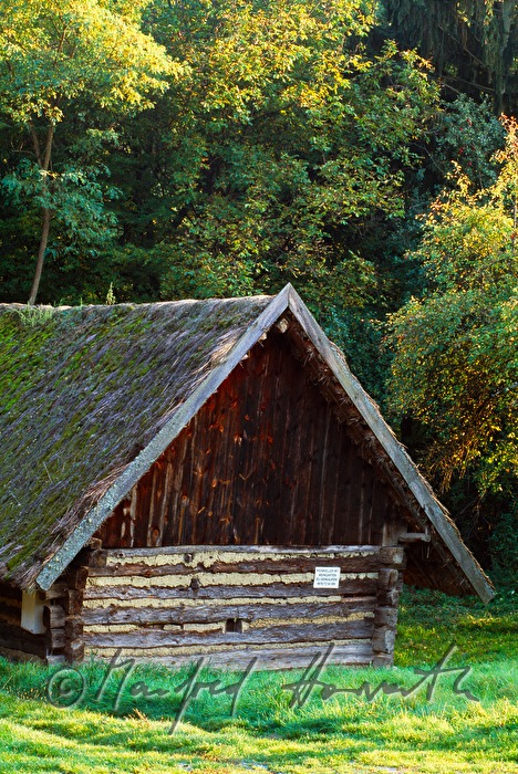 wooden barn with thatched roof
