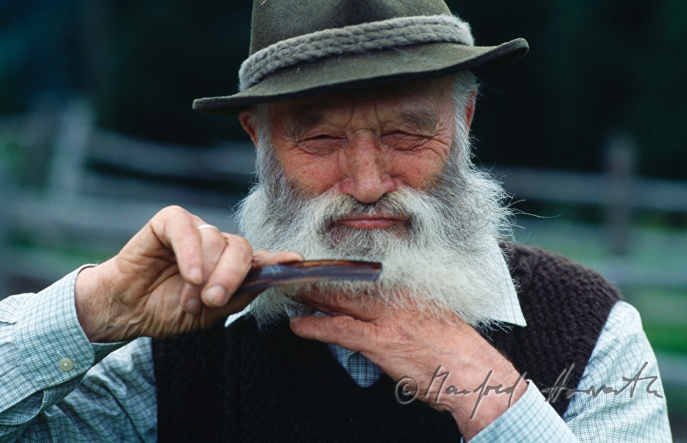 mountain shepherd combs his beard