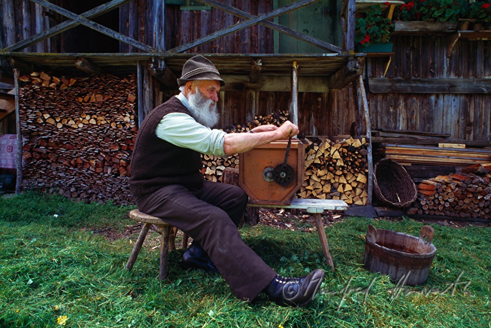 alpine herdsman makes butter