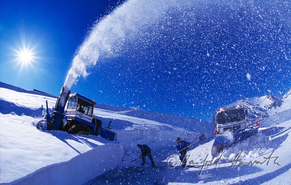 cleaning the street with a snowblower