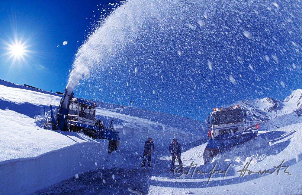 cleaning the street with a snowblower