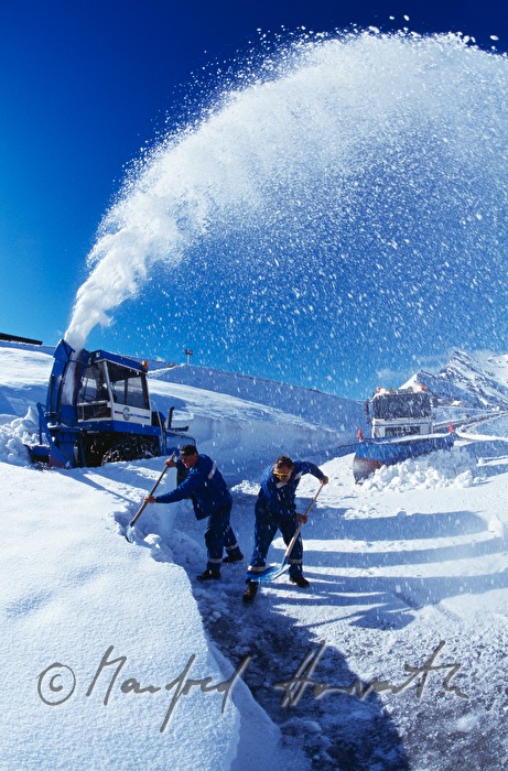 cleaning the street with a snowblower