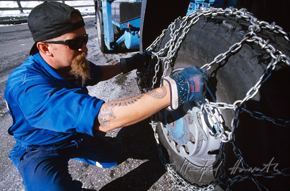 truckdriver attaching the snow chains