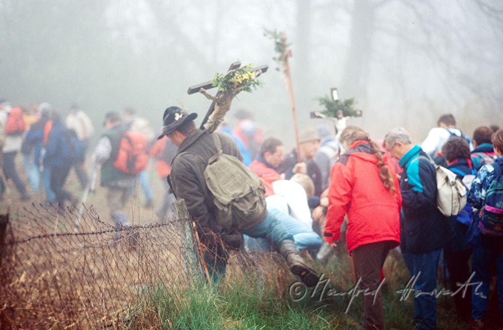 pilgrim surmounts a fence