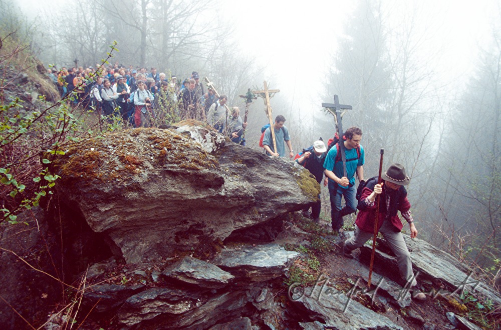 pilgrims pass a narrow place in the forest