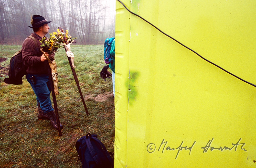 pilgrim waits near the toilet at the open air mass