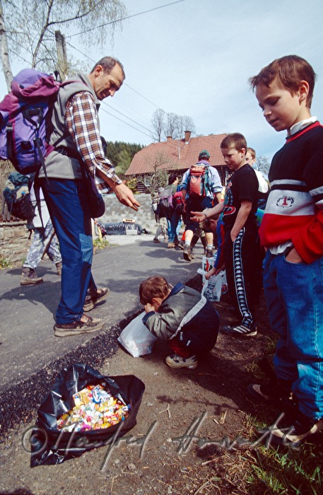 pilgrim gives sweets to children