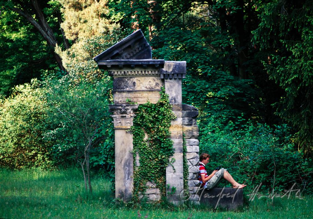 visitor rests on a  ruin