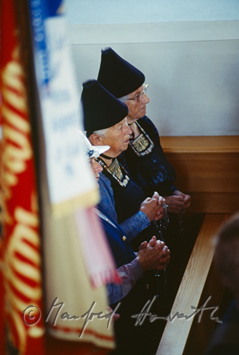 church visitors in traditional costumes