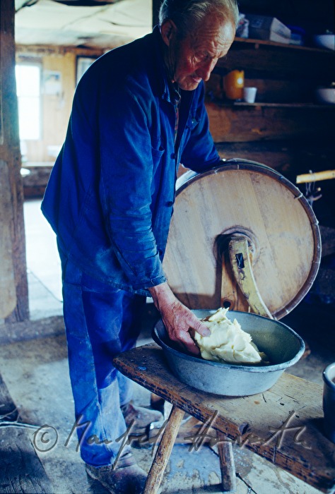 dairyman making butter with a butter chum