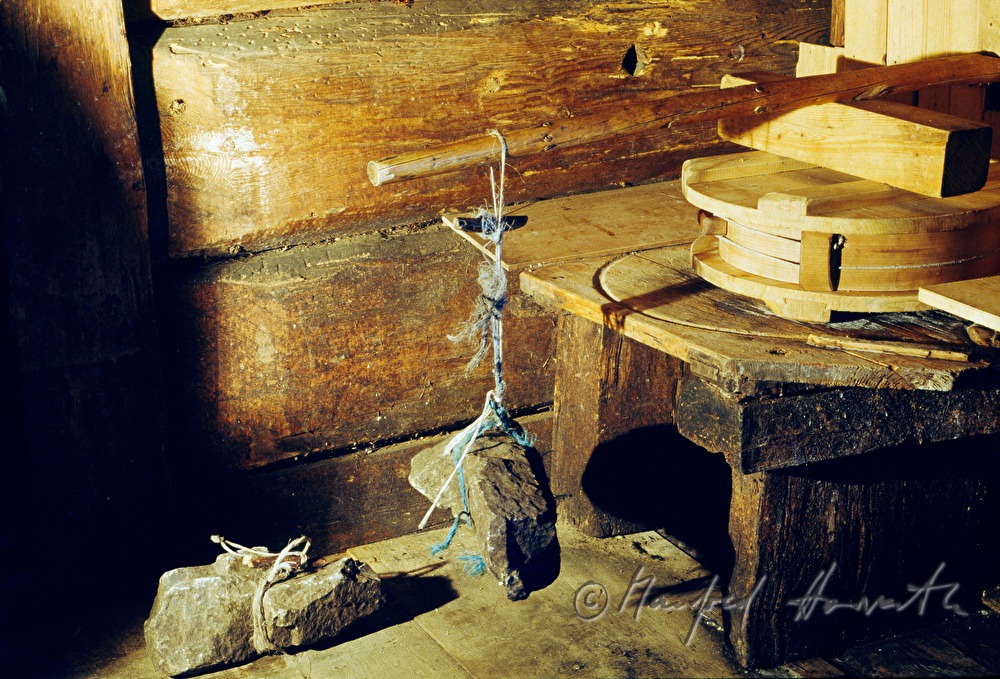 cheesewheel is squeezed in the press